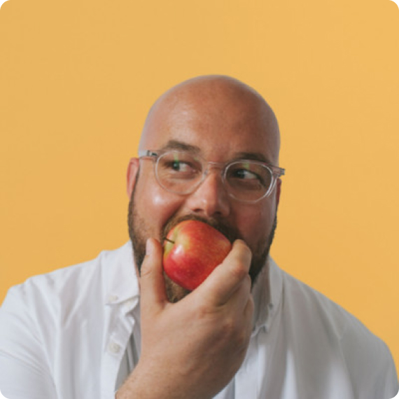 Adam, Founder of Maya Agency, biting apple - Cosmos testimonial